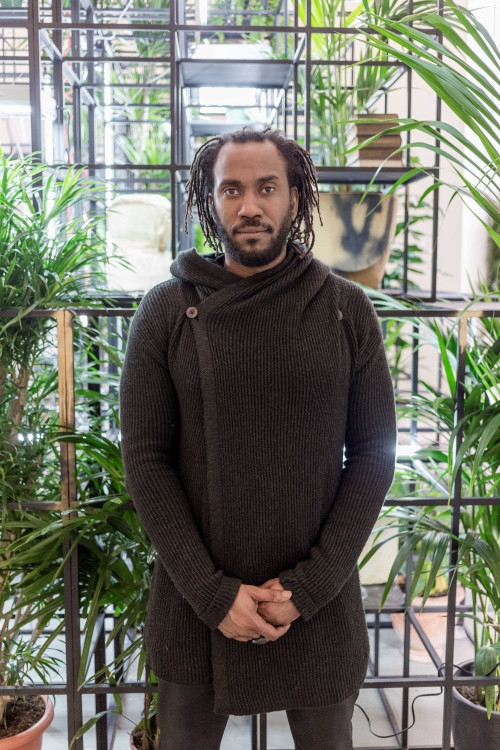 Portrait of Rashid Johnson, in front of his work Plateaus (2014) at Fondation Louis Vuitton, Paris (2017). ©Rashid Johnson. Photo credits: ©Fondation Louis Vuitton / Felix Cornu
